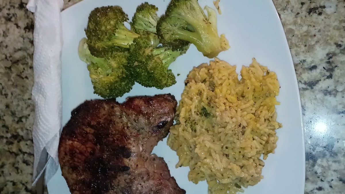 Grilled Pork Chop Dinner with seasoned yellow rice and broccoli